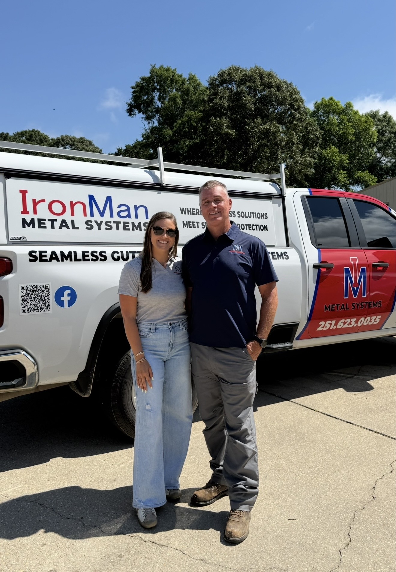 Gary Pledger and his daughter Ciara, owners of IronMan Metal Systems, in front of company truck